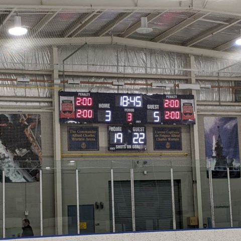 hockey scoreboard being protected by netting